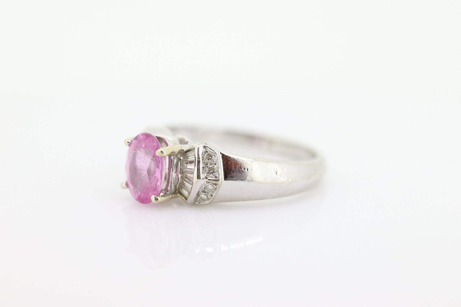 Oval Pink Sapphire Solitaire. 14k white gold with diamond melees st195