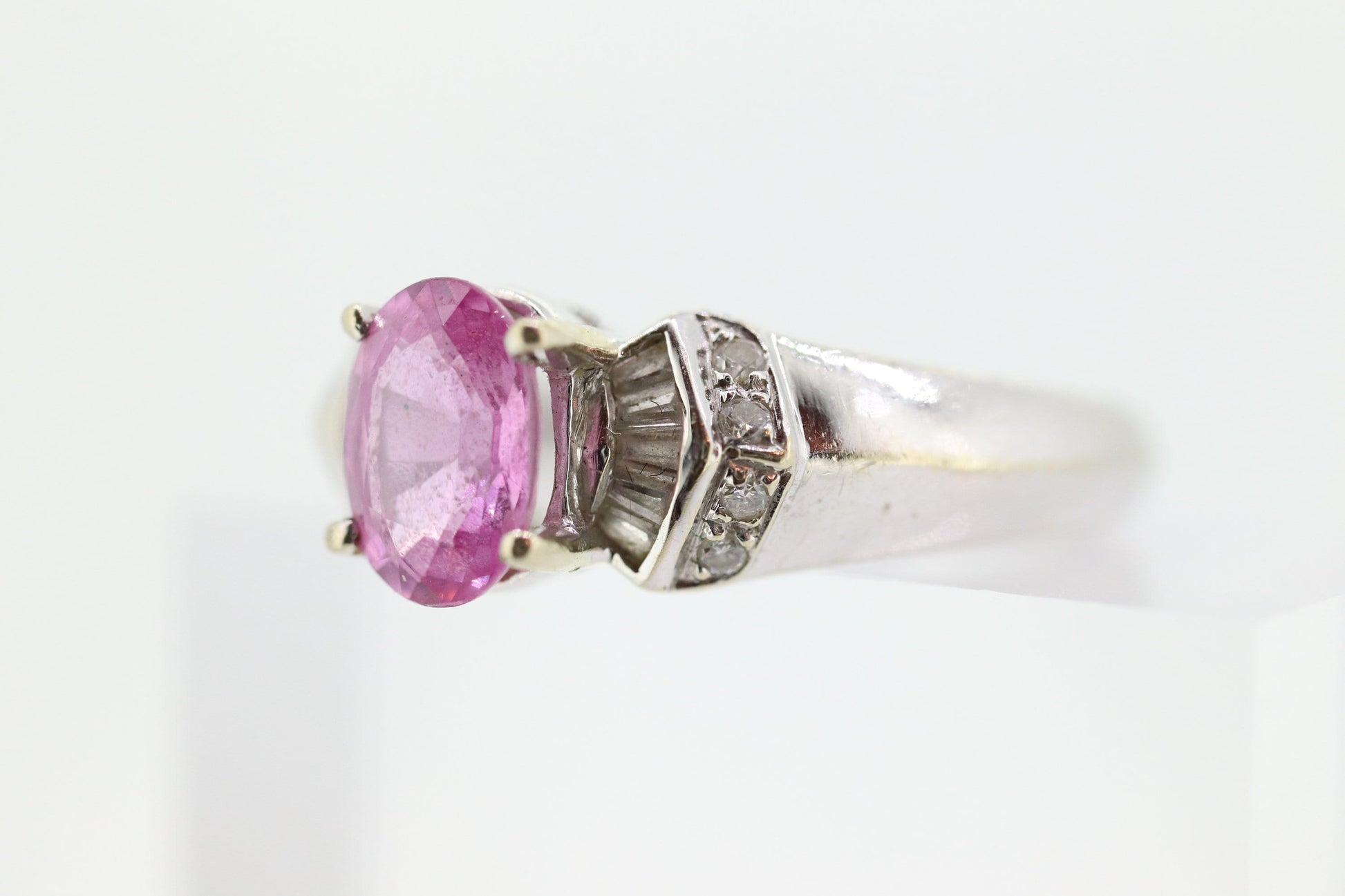 Oval Pink Sapphire Solitaire. 14k white gold with diamond melees st195