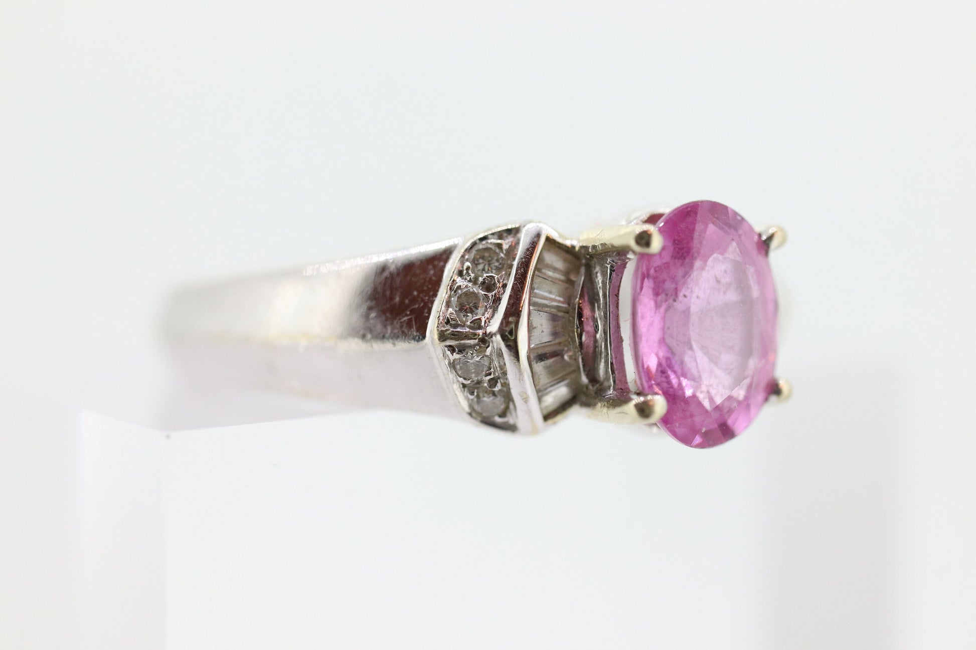 Oval Pink Sapphire Solitaire. 14k white gold with diamond melees st195