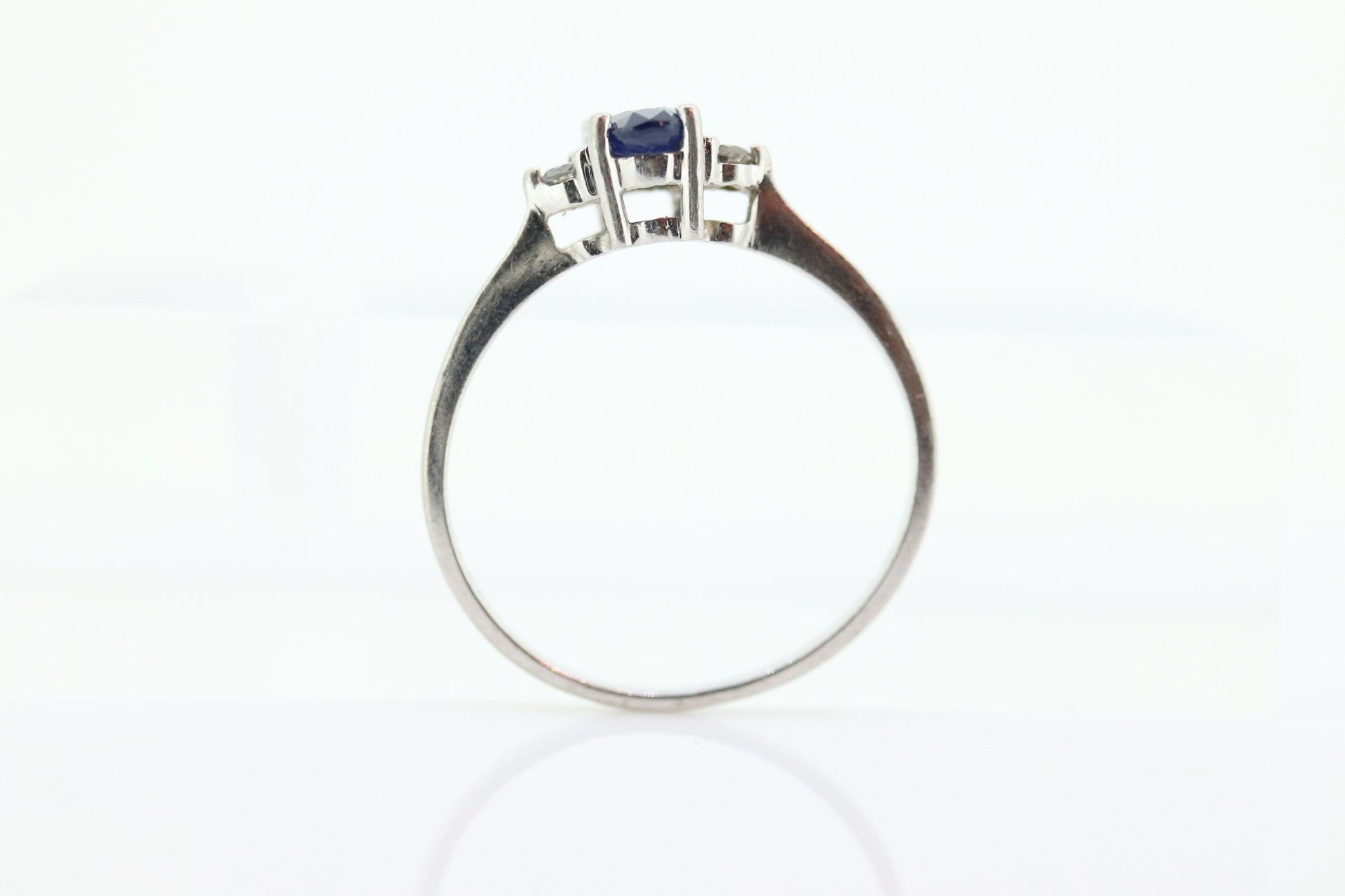 Platinum Sapphire and diamond ring. Oval blue Sapphire solitaire with Diamond accents trilogy ring.