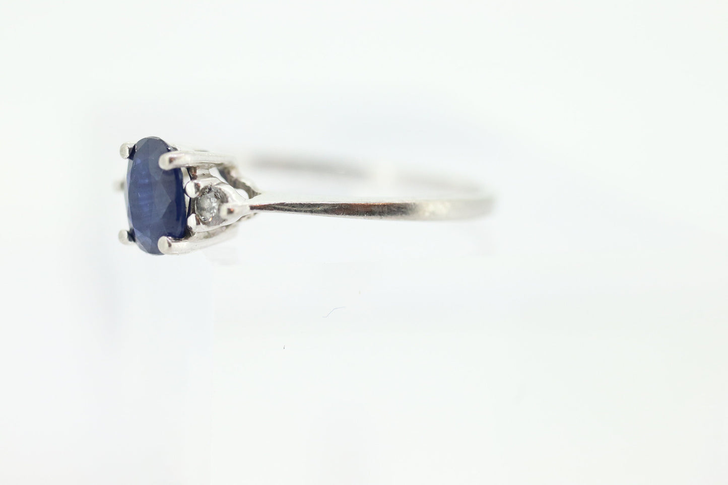 Platinum Sapphire and diamond ring. Oval blue Sapphire solitaire with Diamond accents trilogy ring.