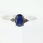 Platinum Sapphire and diamond ring. Oval blue Sapphire solitaire with Diamond accents trilogy ring.