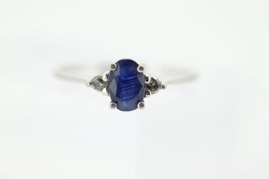 Platinum Sapphire and diamond ring. Oval blue Sapphire solitaire with Diamond accents trilogy ring.