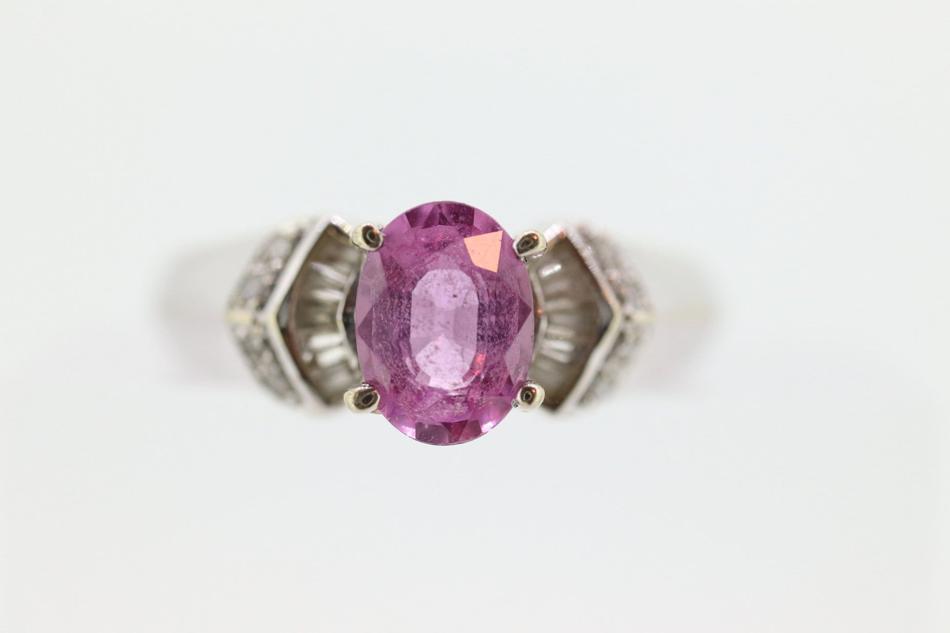 Oval Pink Sapphire Solitaire. 14k white gold with diamond melees st195