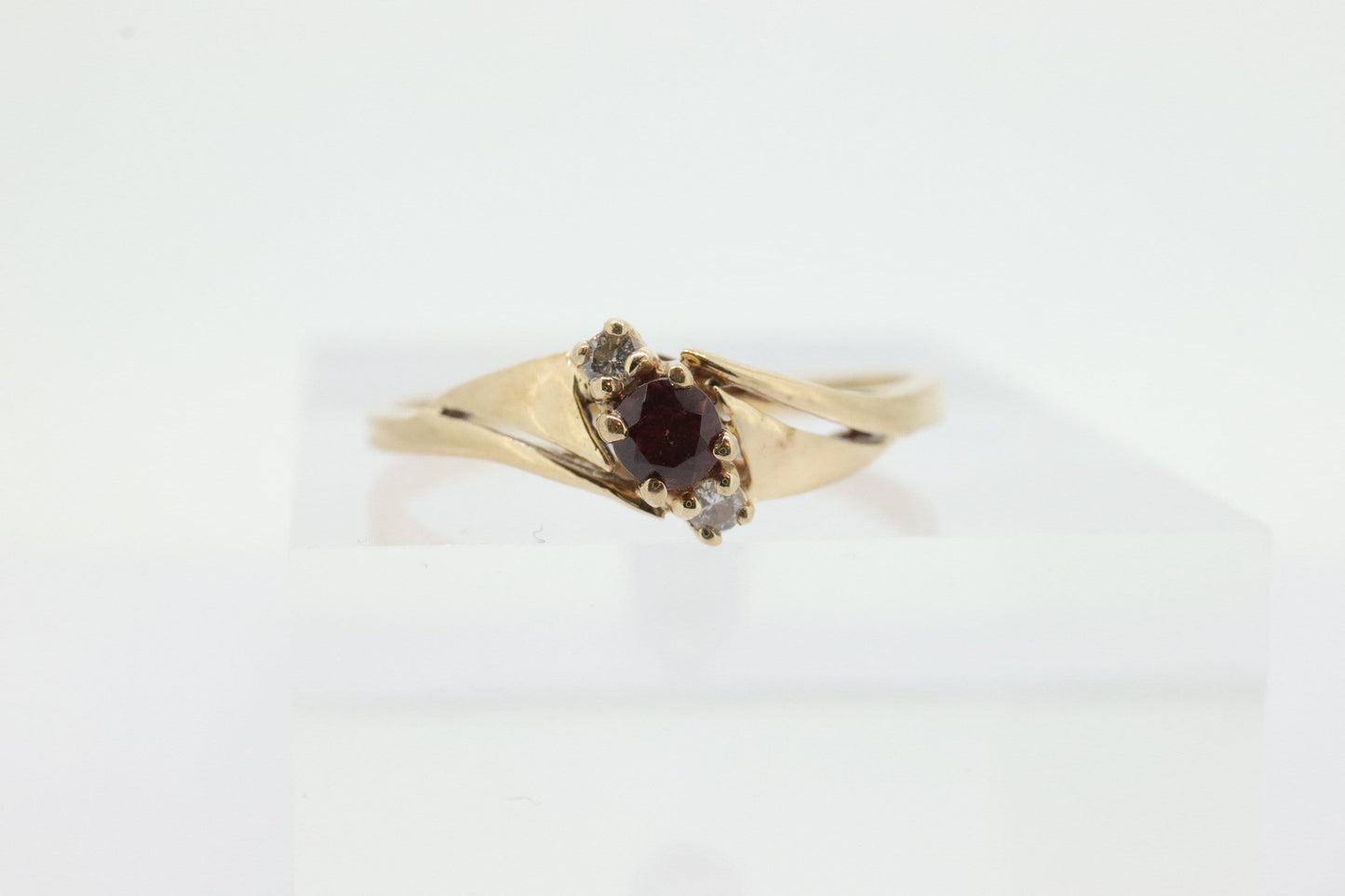 10k Garnet and diamond ring. 10k Round cut garnet with diamonds solitaire. st(62)