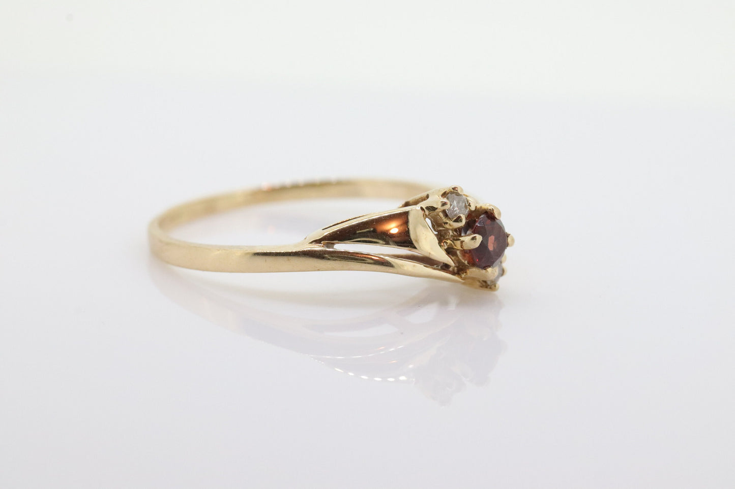 10k Garnet and diamond ring. 10k Round cut garnet with diamonds solitaire. st(62)