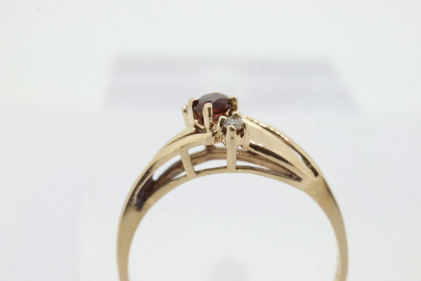 10k Garnet and diamond ring. 10k Round cut garnet with diamonds solitaire. st(62)