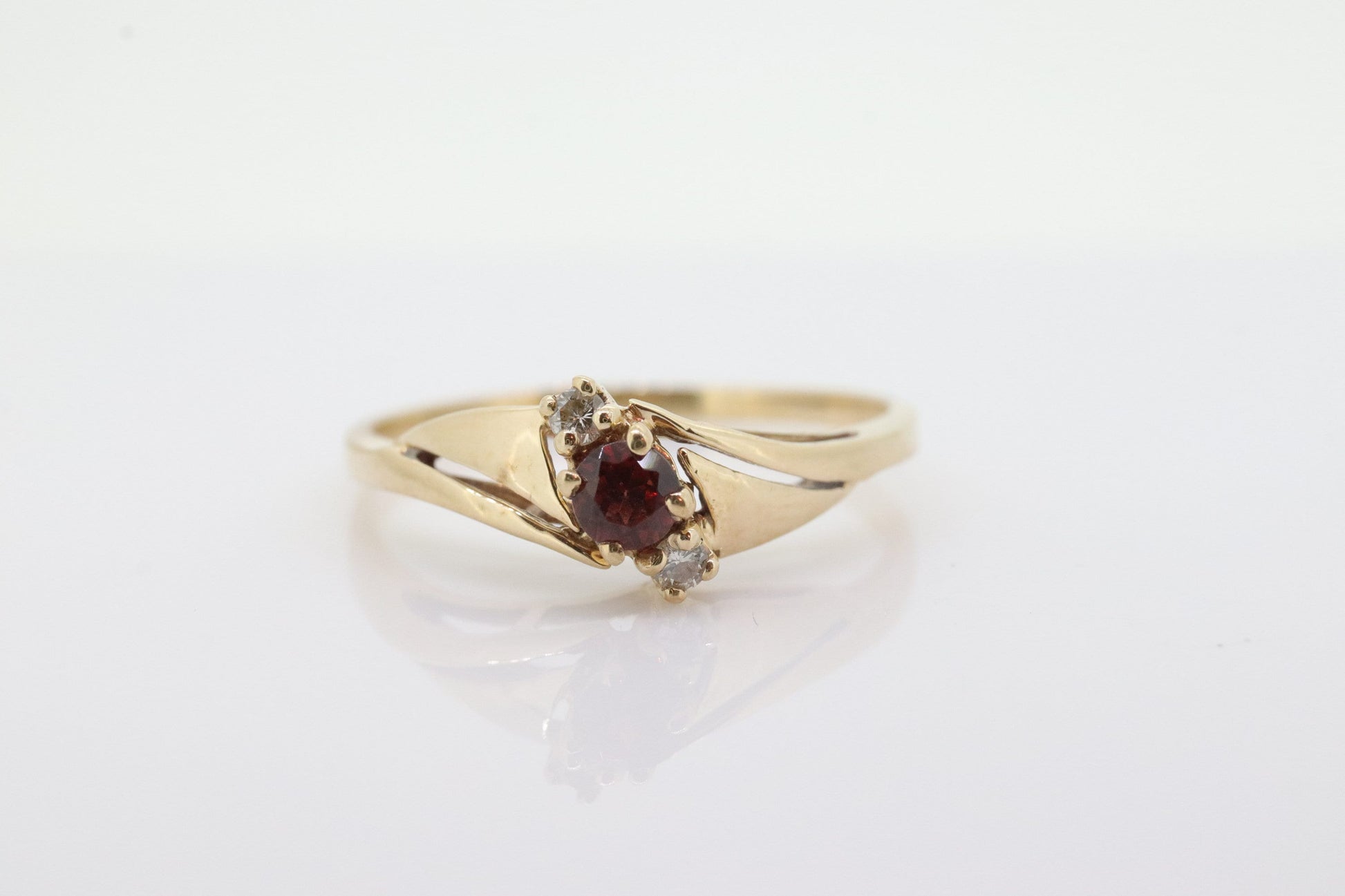 10k Garnet and diamond ring. 10k Round cut garnet with diamonds solitaire. st(62)