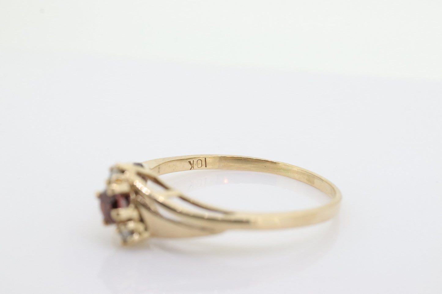 10k Garnet and diamond ring. 10k Round cut garnet with diamonds solitaire. st(62)