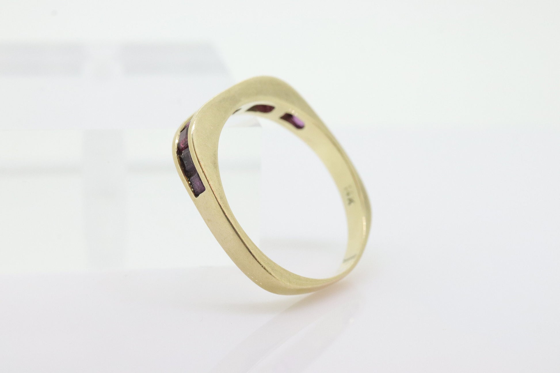 14k Eternity Half Ruby Ring. Euro Shank flat bottom. A 14k gold ring with Princess cut Ruby channel half calibre anniversary band. st(95)