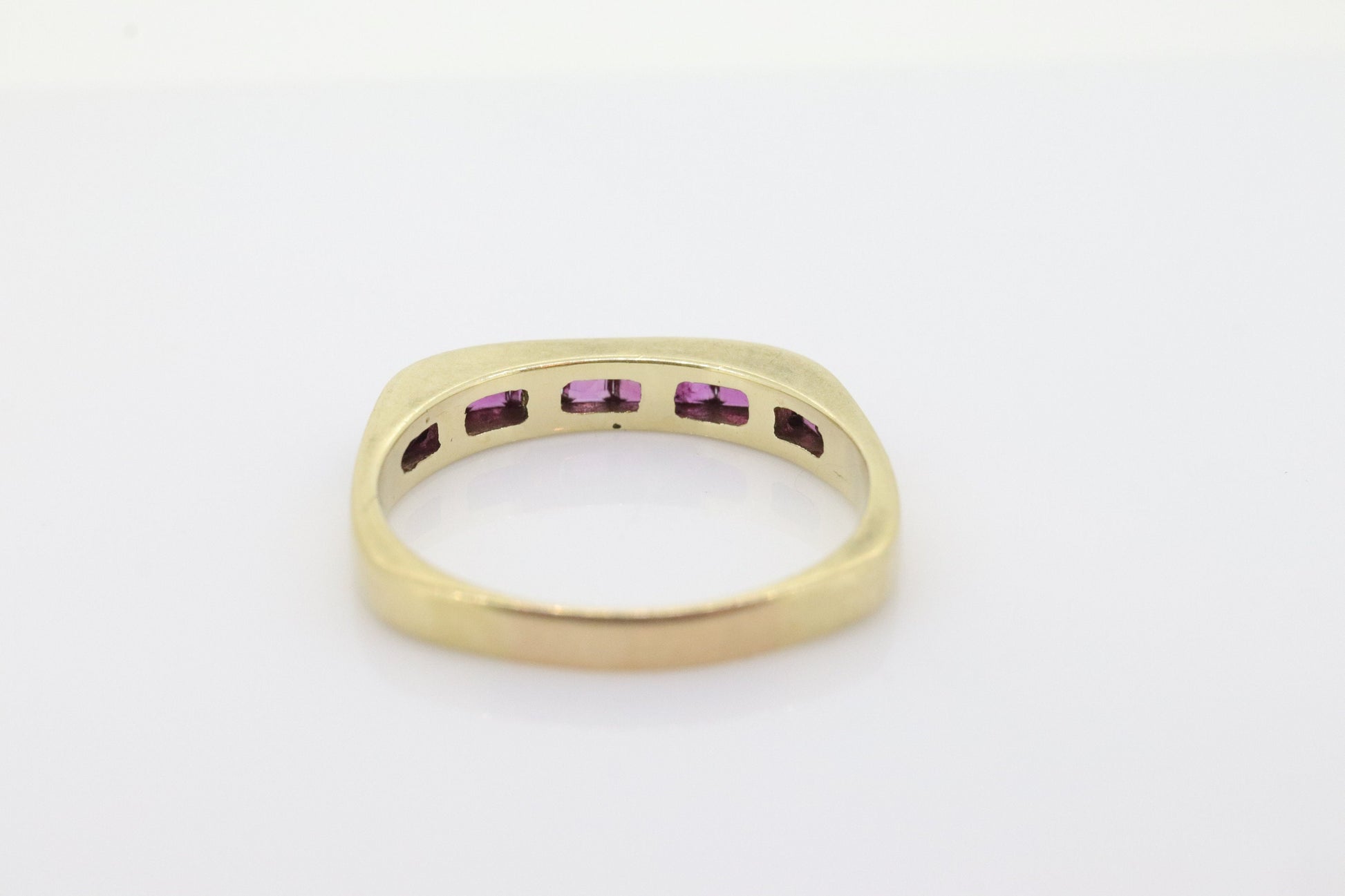 14k Eternity Half Ruby Ring. Euro Shank flat bottom. A 14k gold ring with Princess cut Ruby channel half calibre anniversary band. st(95)