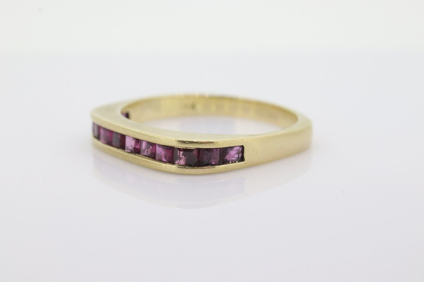 14k Eternity Half Ruby Ring. Euro Shank flat bottom. A 14k gold ring with Princess cut Ruby channel half calibre anniversary band. st(95)