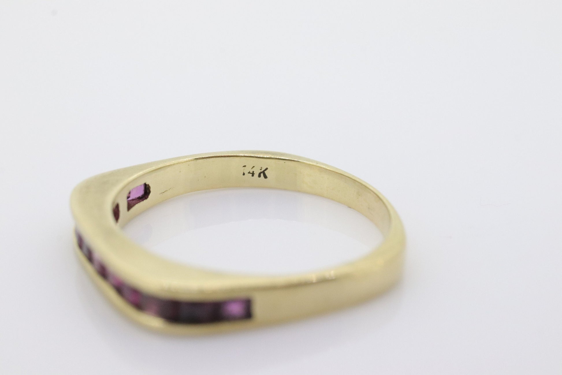 14k Eternity Half Ruby Ring. Euro Shank flat bottom. A 14k gold ring with Princess cut Ruby channel half calibre anniversary band. st(95)