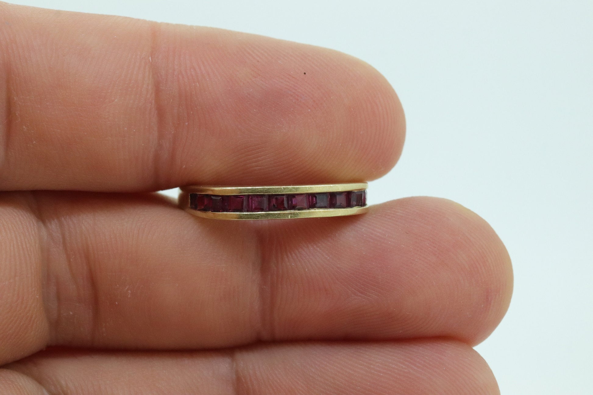 14k Eternity Half Ruby Ring. Euro Shank flat bottom. A 14k gold ring with Princess cut Ruby channel half calibre anniversary band. st(95)