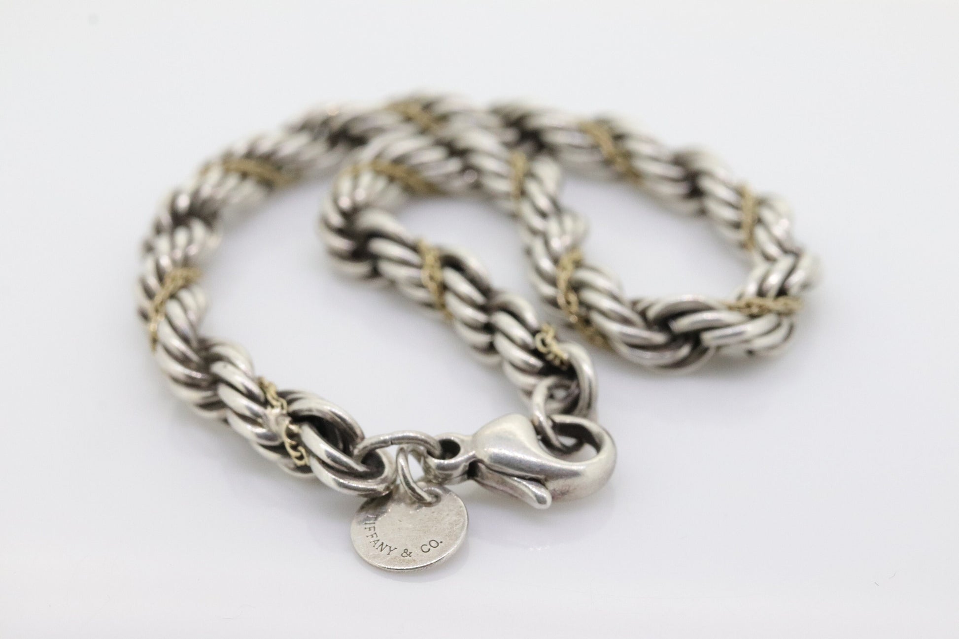 Tiffany & Co. Bracelet. Rope Love Knot Sterling Silver and 18k Yellow Gold Intertwined Bracelet. st(155)