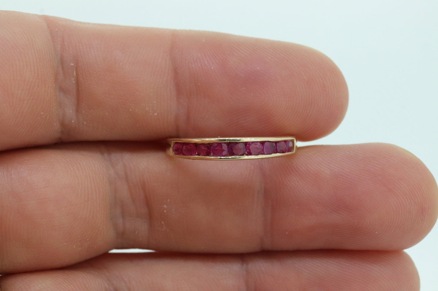 14k Eternity Half Ruby Ring. A 14k gold ring with round Ruby half eternity anniversary band. st(125)