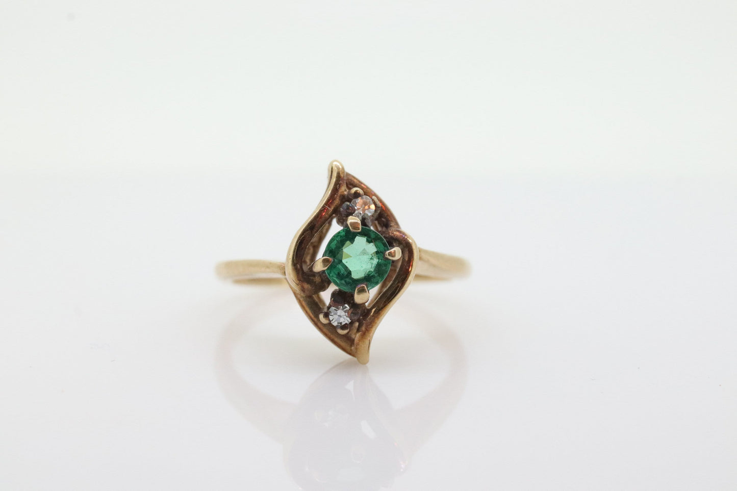 14k round Emerald and diamond ring. 14k Yellow gold marquise shape with diamond accents. st(55)