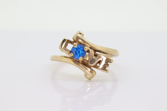 10k LOVE ring. 10k Yellow Gold with round Blue Spinel Solitaire Ring