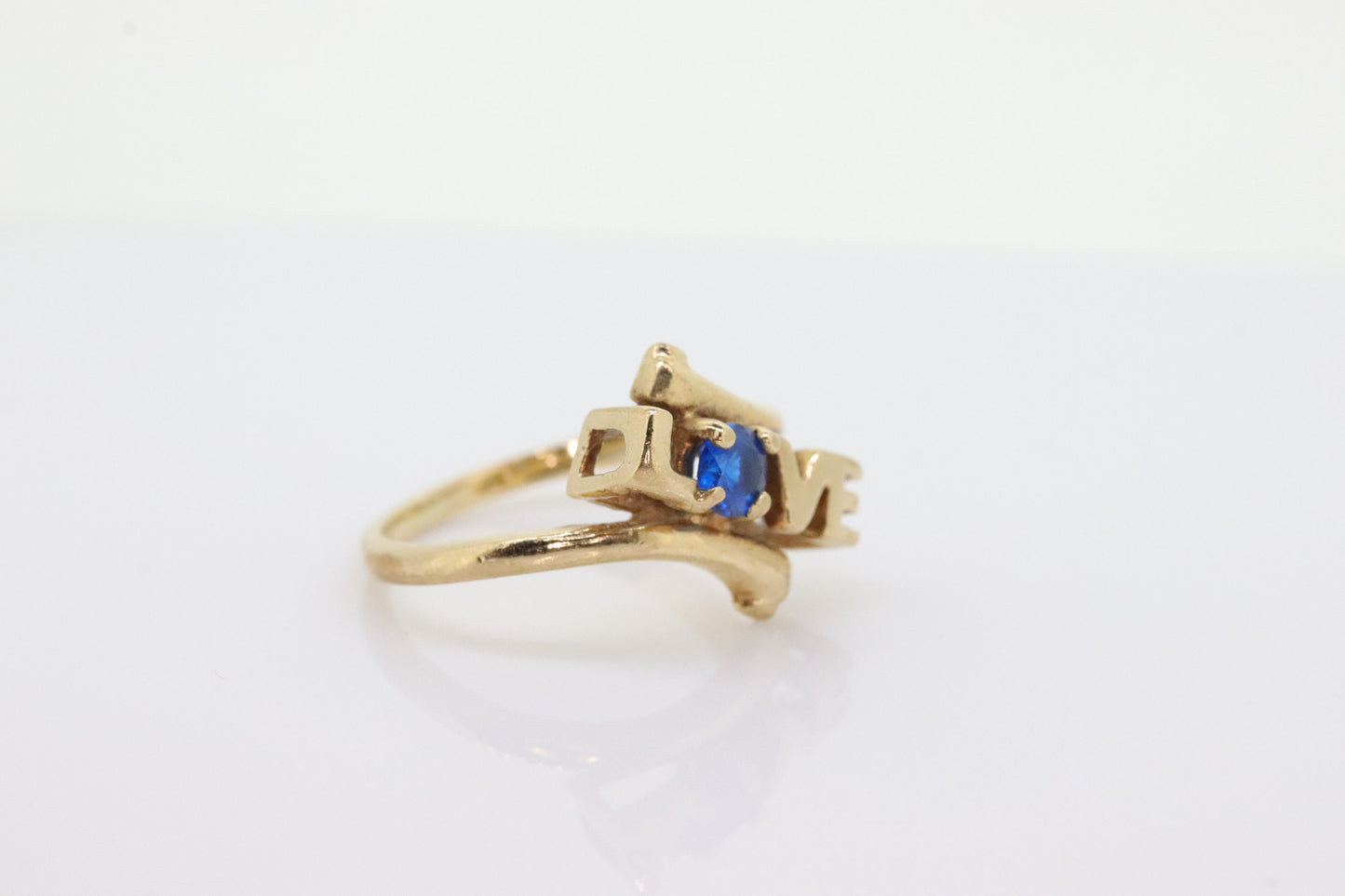 10k LOVE ring. 10k Yellow Gold with round Blue Spinel Solitaire Ring