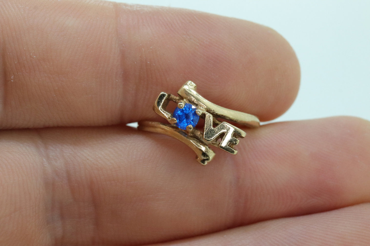 10k LOVE ring. 10k Yellow Gold with round Blue Spinel Solitaire Ring