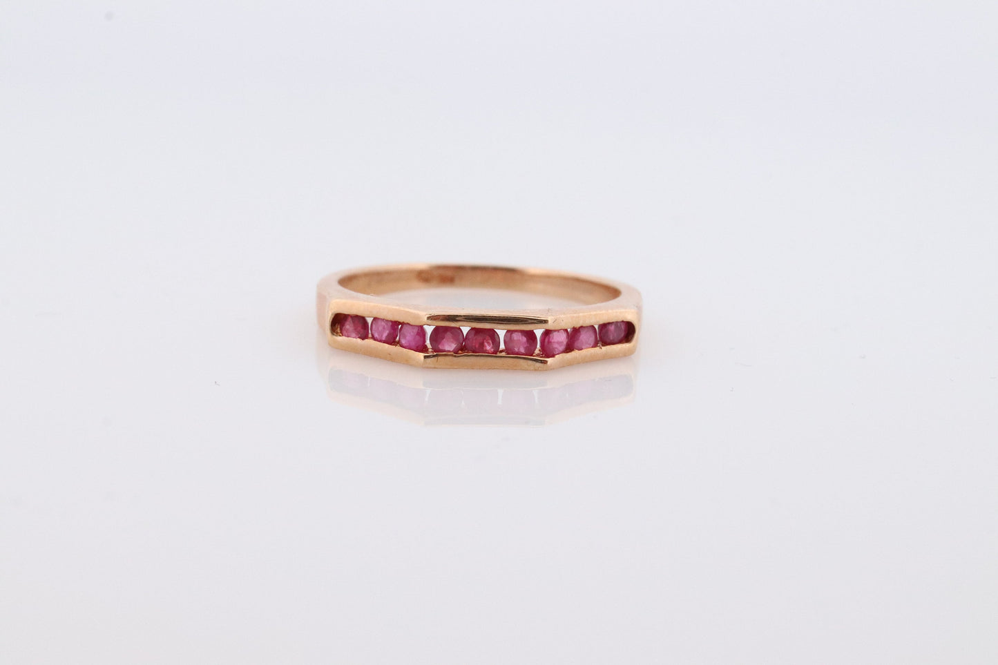 14k Eternity Half Ruby Ring. A 14k gold ring with round Ruby half eternity anniversary band.