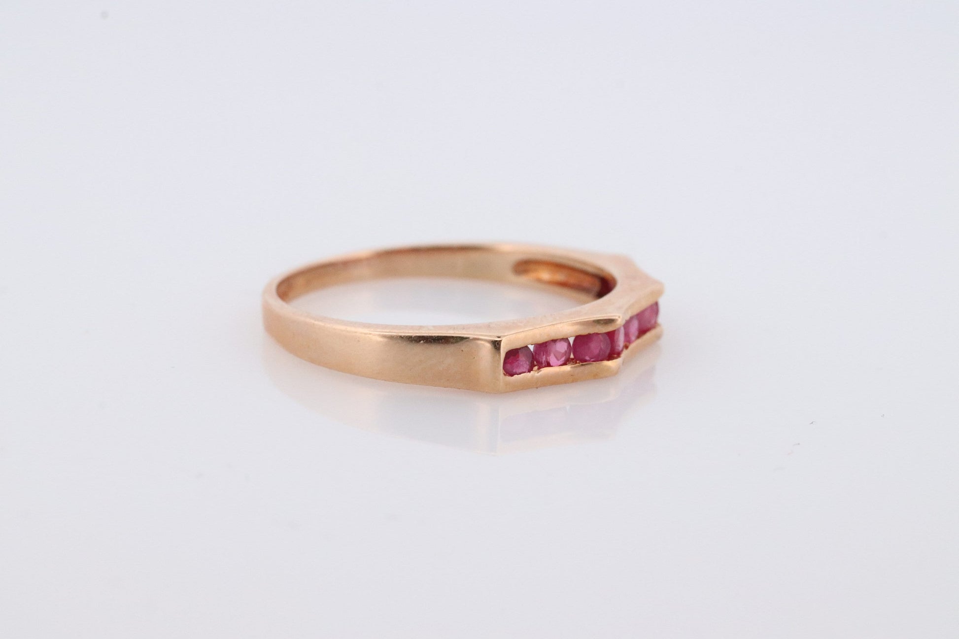 14k Eternity Half Ruby Ring. A 14k gold ring with round Ruby half eternity anniversary band.