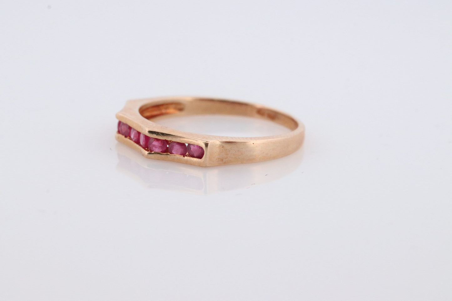 14k Eternity Half Ruby Ring. A 14k gold ring with round Ruby half eternity anniversary band.