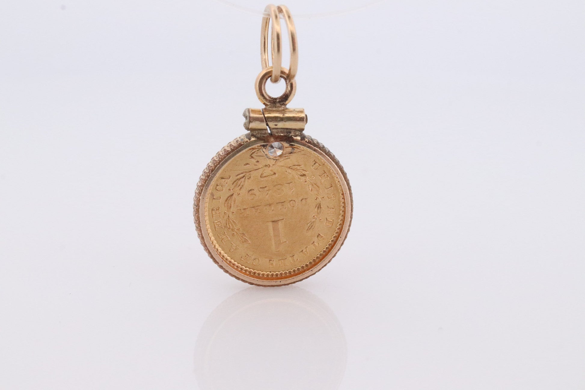 1849 US 1 dollar Liberty Head 900 gold 22K (21.6K) Gold coin set in a 14k yellow gold pendant or charm with a diamond.