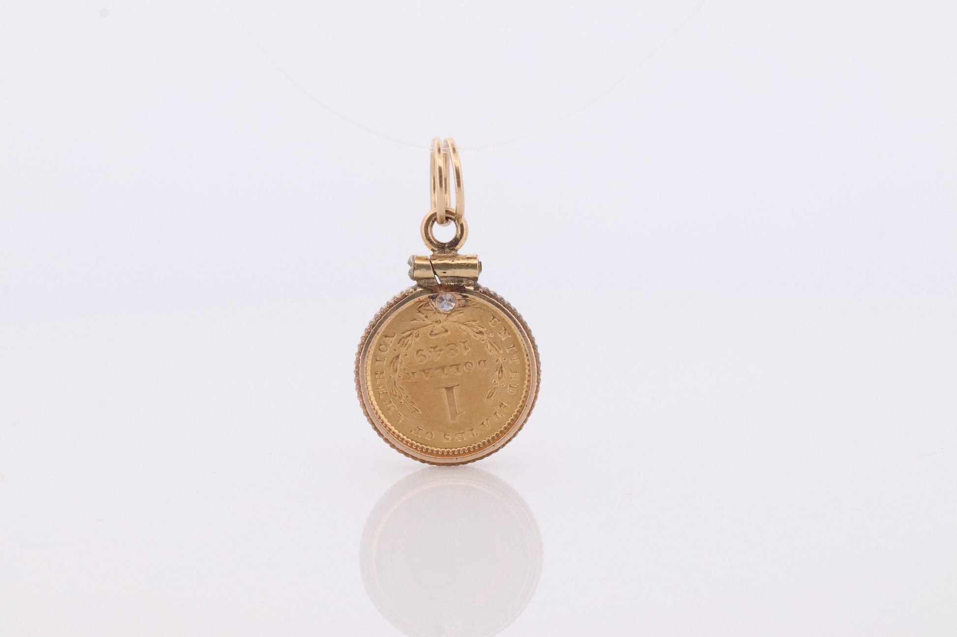 1849 US 1 dollar Liberty Head 900 gold 22K (21.6K) Gold coin set in a 14k yellow gold pendant or charm with a diamond.