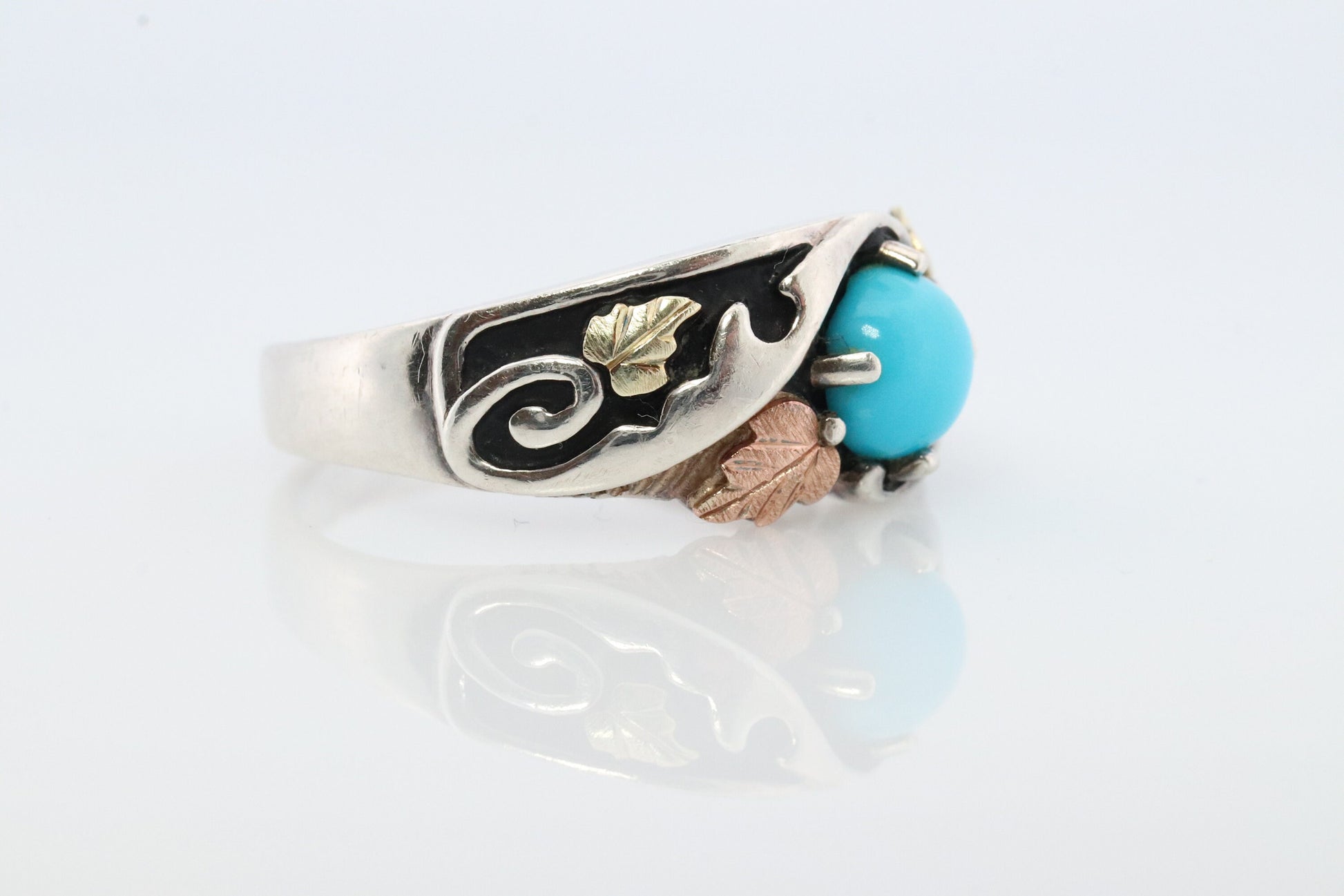 Black Hills Gold Turquoise ring. Sterling Silver and 12k/10k Gold Leaf inlays. Robin Egg color Turquoise cabochon solitaire.