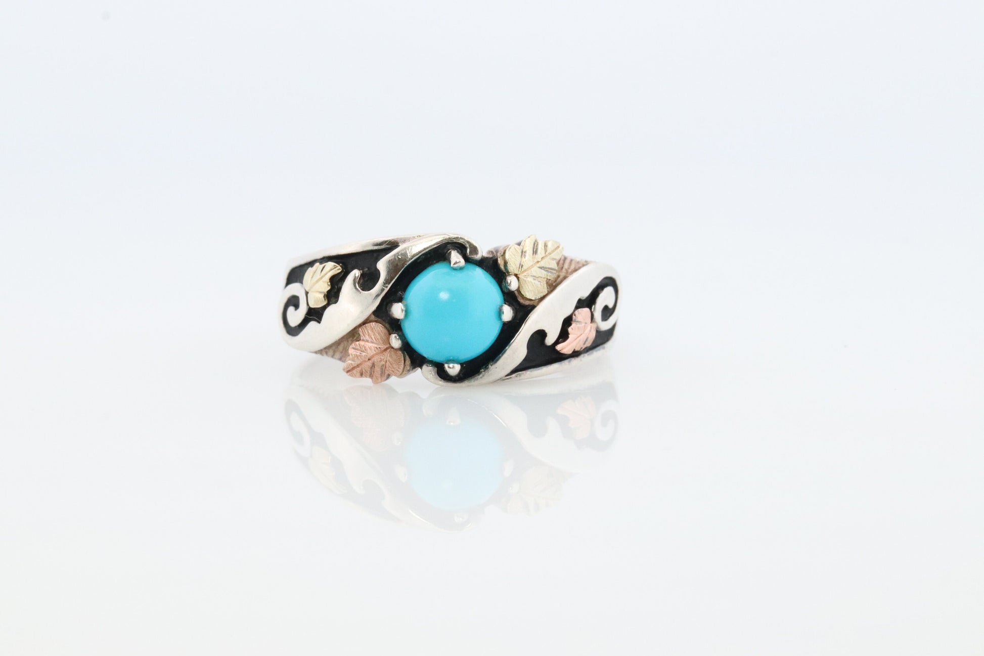 Black Hills Gold Turquoise ring. Sterling Silver and 12k/10k Gold Leaf inlays. Robin Egg color Turquoise cabochon solitaire.