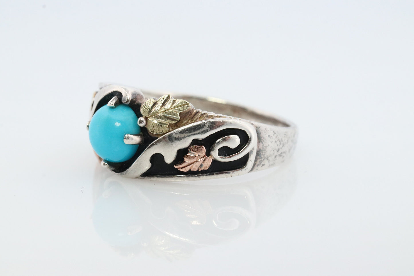 Black Hills Gold Turquoise ring. Sterling Silver and 12k/10k Gold Leaf inlays. Robin Egg color Turquoise cabochon solitaire.