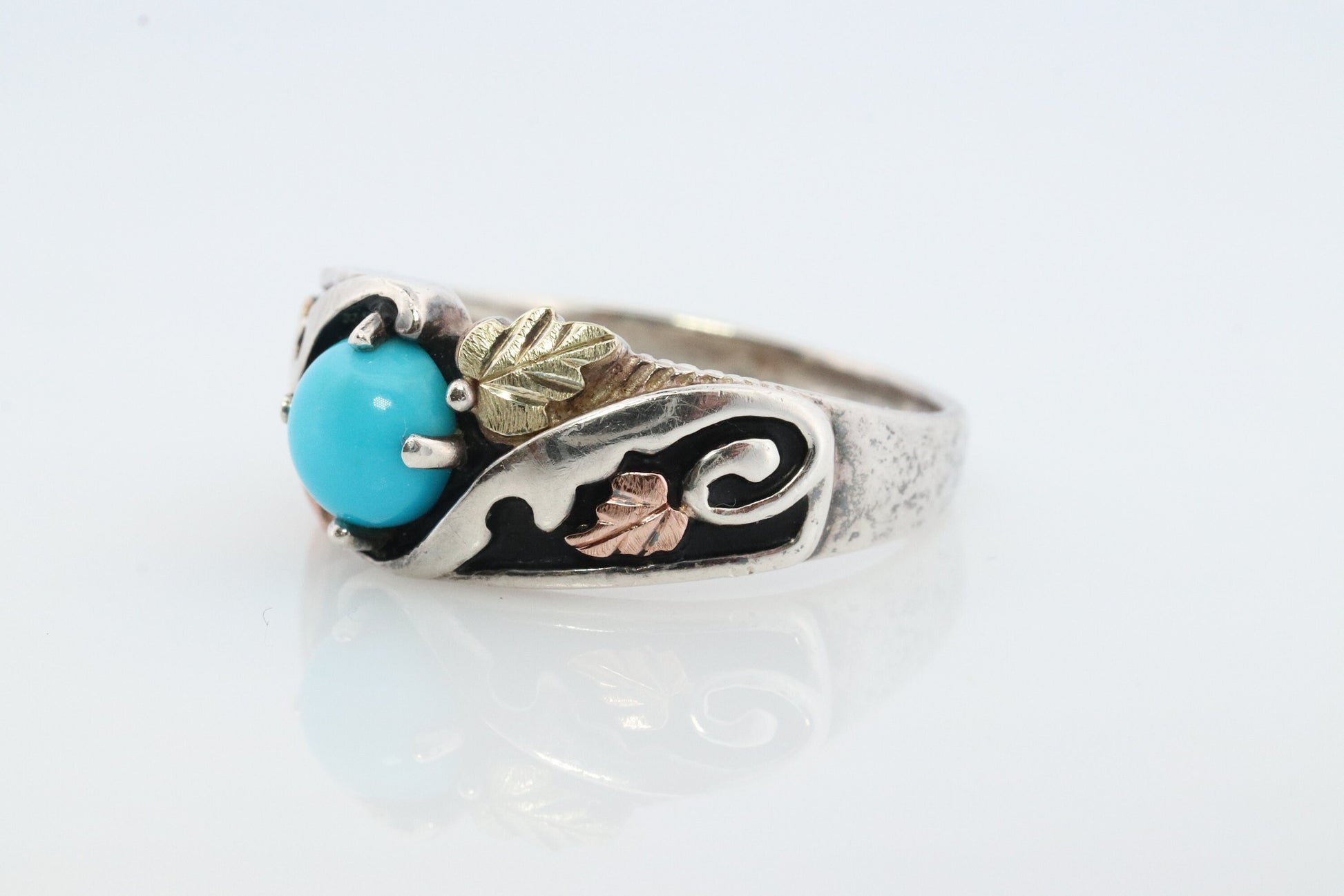 Black Hills Gold Turquoise ring. Sterling Silver and 12k/10k Gold Leaf inlays. Robin Egg color Turquoise cabochon solitaire.